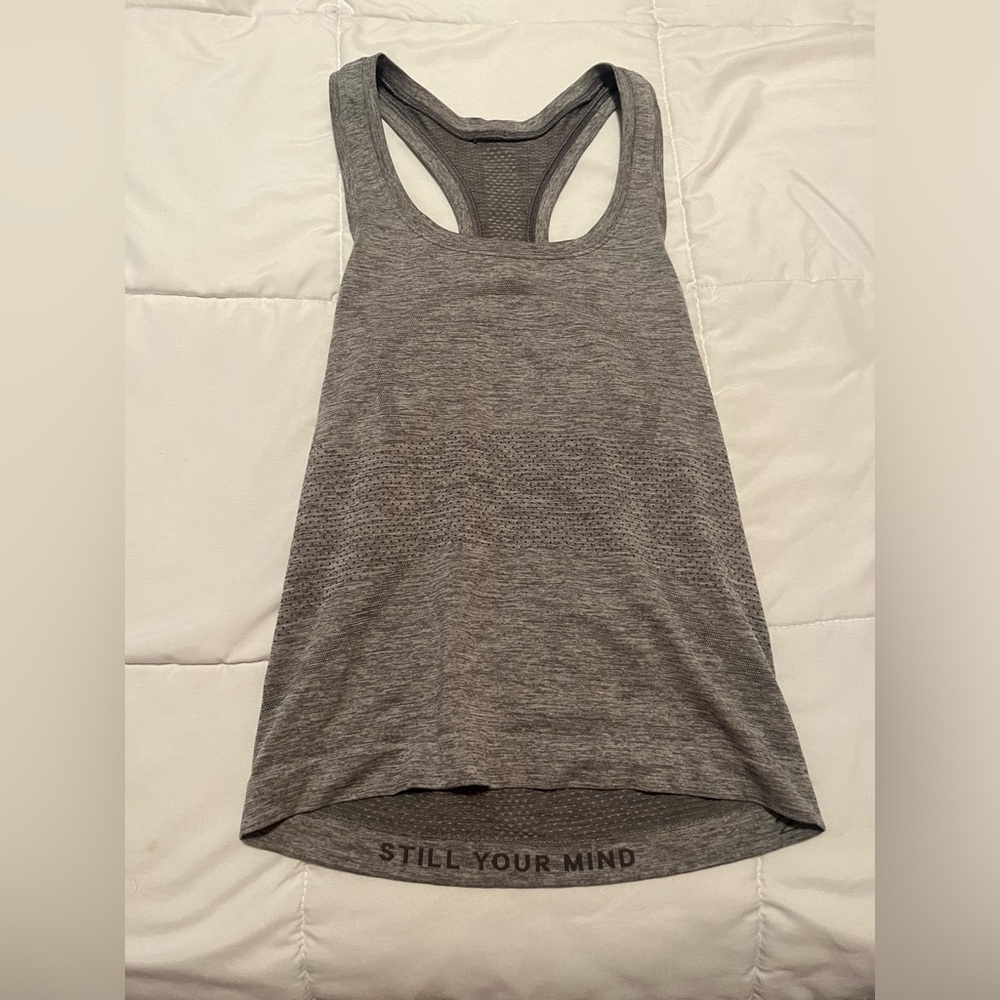 Three. Lululemon racer back, tank tops. All size 2. Barely worn great condition.